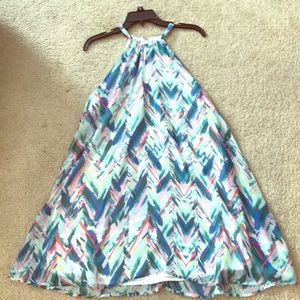 Sleeveless strapped flowing dress.